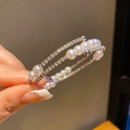 Macro shot of double-layer bracelet with pearls and shimmering pave crystals - 25# Bracelet - Silver