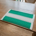 Bohemian green and white striped woven placemat with tassels on a wooden dining table - White Green Block