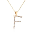 Macro shot of 18K gold plated letter F pendant with baguette cut cubic zirconia - Letter F