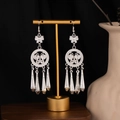 Detailed close-up of Bohemian butterfly earrings with silver hollow tassels and ethnic patterns - Butterfly Hollow Tassel Style E6049-3