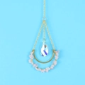 Macro shot of gold suncatcher with pink raw crystals and faceted teardrop prism pendant - Rose Quartz/Metal/Crystal / Rose Quartz