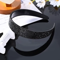 Elegant black rhinestone padded headband with sparkling crystals on reflective surface - Obsidian Black Solid Full Rhinestone