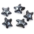 Macro view of five black star-shaped ceramic beads with a shiny polished finish for DIY jewelry - Black (16#)