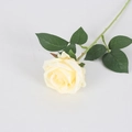 Single light yellow artificial velvet rose with green leaves on white background - Silk Champagne