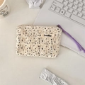 Detailed top view of a cream floral makeup bag with lace trim on a minimalist workspace - Cream White Base Black Floral Lace / Black Floral