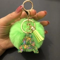 Green faux fur pompom keychain with golden tassel and glittery resin letter A pendant - Letter A