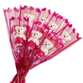 Close-up of eight white teddy bears in pink dresses wrapped in heart pattern plastic - Rose Red Bear Without Flower