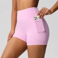 Detailed view of pink yoga shorts showing functional side pocket for mobile phone - Sakura Pink