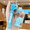 Blue bubble tea bear keychain with drifting liquid, beads, and a silicone dream strap - Jelly Squeezer - Blue