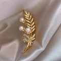 Macro shot of gold wheat brooch with pearls and zircons on grey silk background - 416# Leaves
