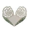 Close-up of white laser-cut paper favor box featuring intricate rose flower lace patterns - Reflective Green