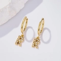 Golden R-shaped letter earrings with white zircon stones on a minimalist white stone background - Letter R (Style: 0229)