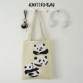 Detail of a beige knitted panda tote bag with earphone and keychain accessories - Three Bears Apricot