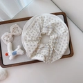 Detailed macro view of white floral cotton scrunchie with blue prints on ceramic tray - Literary Blue Floral Stripes on Beige