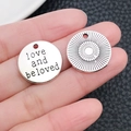 Detailed macro view of antique silver charms engraved with love and beloved and sun pattern - Round Loveandbeloved Letter Tag (2490)