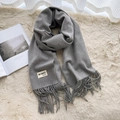 Classic grey cashmere-feel scarf with fringes and minimalist brand label on cozy rug - Light Heather Grey