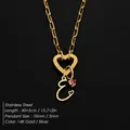 Elegant gold stainless steel necklace with heart clasp and crystal initial E pendant. - Letter E
