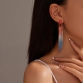 Elegant long gradient tassel earrings with multicolored rhinestones on model's ear - Red Blue White Gradient Long Tassel (DTE1617002R-W-BU)