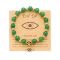 Evil Eye beaded bracelet with green stones and gold spacers on a gift card display - Green Aventurine