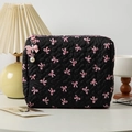 Black quilted makeup bag featuring pink bow patterns and a pearl zipper charm detail - Medium / Black Pink