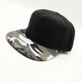 Black snapback hat featuring a grey camouflage flat brim with cotton twill texture - One Size / Black + Camo Brim