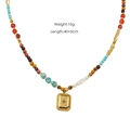 Ethnic natural stone beaded necklace with a golden tiger eye pendant on a white background - Natural Stone Beaded