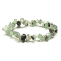 Macro shot of irregular light green natural crystals and black inclusions on handmade bracelet - Green Rutilated Quartz