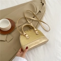 Champagne gold shell shaped handbag with woven texture and a slim shoulder strap - Gold