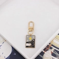 Close-up of The Star cat tarot card keychain with enamel finish and gold clasp - Star