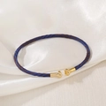 Detail view of woven blue and brown cord bracelet with polished gold-plated metal ends - Blue Brown