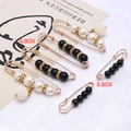 Set of two gold-finish waist adjustment pins with white pearls and black rhinestones - Black And White Bead Retro Set
