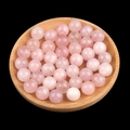 Pink natural crystal quartz round beads for DIY jewelry making in a wooden tray - 12mm Rose Quartz Semi Drilled Bead
