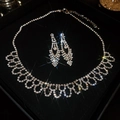 Close-up of sparkling rhinestone waterdrop tassel necklace and earrings set in a gift box - Full Diamond Inlaid Water Drop / Silver