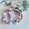 Gradient 8mm cat eye glass bead bracelet featuring colorful spiral patterns and white beads - Millefiori Glass Round Bead