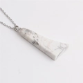 Macro view of trapezoidal white marble stone pendant on a silver metal chain necklace - White Marble Pattern (Silver Chain)