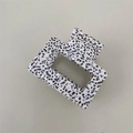 Close-up of square acetate hair claw clip featuring a black and white spotted marble texture - Small Square / White