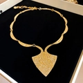 Detailed view of a vintage gold-toned textured oval pendant necklace in a black velvet gift box - 25# Necklace Relief Carving Inverted Triangle Rhombus