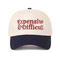 Macro shot of red embroidery on the beige crown and navy blue brim of the baseball cap - Beige/Navy Blue