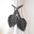 Close-up of dark grey hand-woven cotton leaf curtain tiebacks with natural wooden beads - Leaf Shape Style / Gray