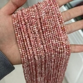 Pink faceted natural stone beads strand held by hand for jewelry making diy projects - Argentina Rhodochrosite 3mm