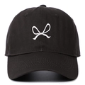 Close-up of white bow embroidery on a black cotton baseball cap with ventilation eyelets - Dark Gray
