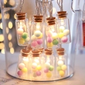 Warm white LED string lights featuring glass jars filled with colorful pom-poms - Macaroon Pom Pom Style / 1.5M 10-LED (2-AA Battery Box)