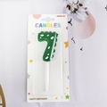 Green dinosaur number 7 birthday candle with white polka dots and plastic holder - Number 7