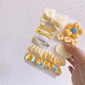 Detail view of yellow floral hair clips and scrunchies set on white display card - Yellow - 9Pcs Set (With Card)
