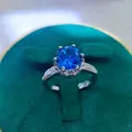 Macro shot of 2ct round blue sapphire ring with pavé side stones in velvet box - A8 Open Type / Blue