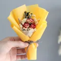 Detailed close-up of mini bouquet with dried red roses and yellow wrapping - Red Rose (Yellow Wrapping)