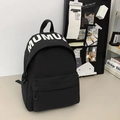 Minimalist black student backpack with white MUMU lettering on a cream desk surface - Large / Black