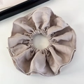 Detailed texture of khaki double-layered fabric scrunchie on a clean white background - Apricot White