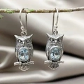 Vintage oxidized silver owl earrings with sky blue topaz stones on a decorative branch - Owl With Light Blue Gemstone / Sky Blue