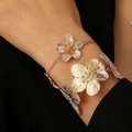 Golden flower bracelet set with textured petals for women in elegant jewelry style - Gold Flower Bangle + Bracelet Set